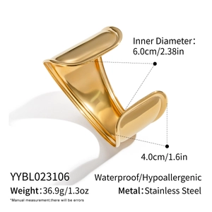 Macro shot of 18K gold plated stainless steel wavy wide bangle with size and weight info
