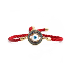 Evil Eye red braided rope bracelet with gold-tone accents and blue zircon charm