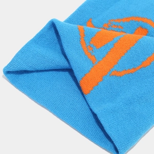Close-up of royal blue knitted beanie with orange orbital planet jacquard pattern