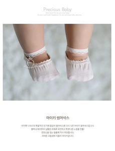 Close-up of baby lace princess socks in cream cotton with breathable mesh for summer