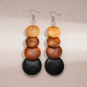 Detail of bohemian wood bead earrings showing brown to black gradient geometric discs