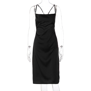 Detailed front view of black satin slip dress with thin straps on clear mannequin