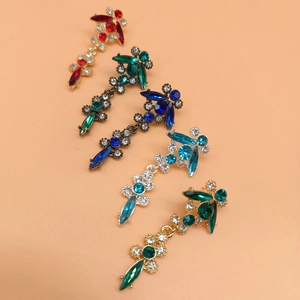 Detail view of five vintage alloy floral brooches featuring colorful crystal rhinestones