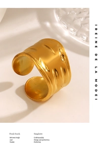 Detail of vintage gold-plated wide ring with hand-hammered texture and metallic luster