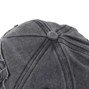 Detail of vintage washed charcoal baseball cap showing fabric texture and crown stitching