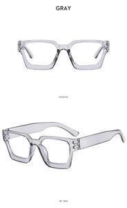 Detail view of thick gray transparent square frame sunglasses from positive and side angles