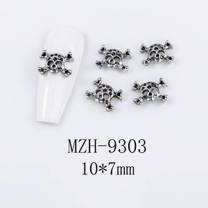 Detailed view of vintage silver skull alloy nail charms showing 10x7mm dimensions