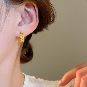 18k gold plated minimalist textured coin circle hoop earrings worn by a model