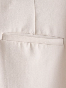 Macro shot of beige woven fabric texture and stitching detail on the pocket seam