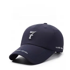 Detail of navy blue baseball cap featuring white number seven and letter embroidery
