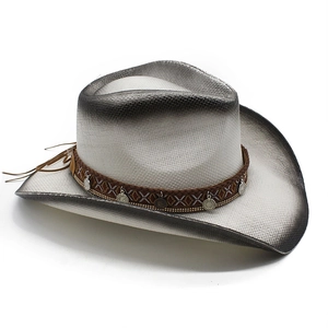 Detail of hand-woven straw cowboy hat with gradient ombre finish and silver coin band