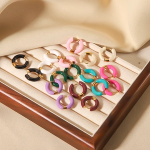 Set of colorful enamel hoop earrings in gold plated stainless steel on a velvet jewelry tray