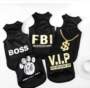 Flat lay of breathable black mesh pet vests with assorted graphic prints for small dogs