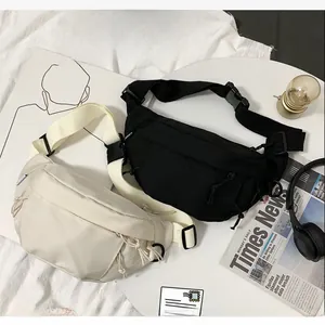 Detail view of black and beige nylon chest bags with adjustable straps and zipper compartments