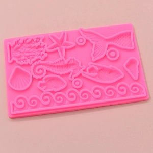 Pink silicone ocean theme cake mold featuring seahorse starfish and shell shapes