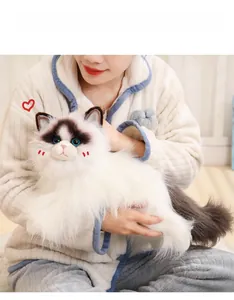 Close-up of realistic plush ragdoll cat with soft long fur and blue glass-like eyes