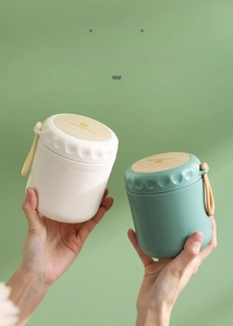 Close-up of portable stainless steel breakfast cups with wood texture lids and carry straps