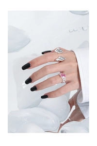 Detail view of S925 silver rings with pink square gemstone and liquid metal lava texture