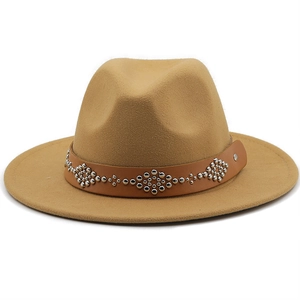 Detail of the brown leather belt with silver floral studs on a camel wool fedora hat