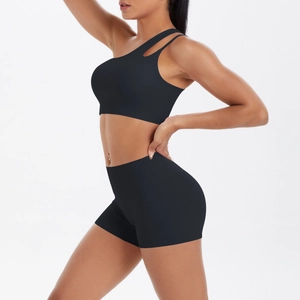 Side view of black one-shoulder sports bra and high-waisted shorts set on model