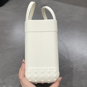 Detailed side view of a white EVA beach tote bag showing durable material texture