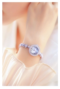 Close-up of elegant silver BS Bee Sister watch featuring floral rhinestone chain bracelet