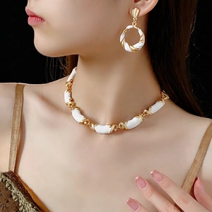 Vintage style twisted gold and white enamel jewelry set with necklace and earrings