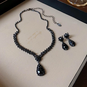 Vintage jewelry set featuring black pear-cut zircon necklace and drop earrings in dark finish
