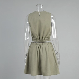 Detail of the back opening button and elastic waist on khaki cotton linen two-piece set