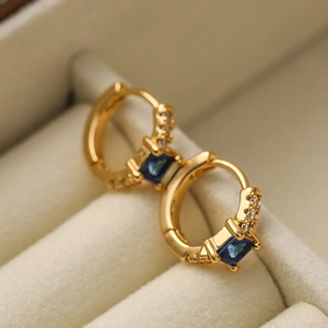 Gold-plated mini geometric hoop earrings with blue sapphire square zircon on beige velvet