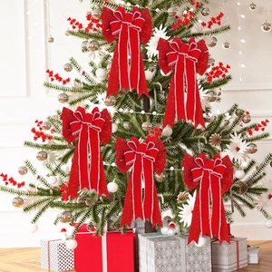 Five red flocked Christmas bows with white fur edges decorating a festive Xmas tree