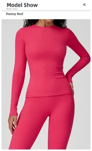 Front view of model wearing peony red slim-fit long-sleeve yoga top and leggings