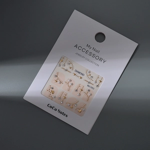 3D heart nail art stickers with gold metal accents, pearls, and rhinestones on card