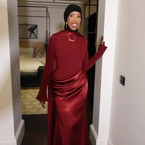 Detailed view of the elegant wine red satin dress with pleated waist and modest long sleeves