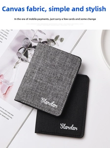 Detail view of ultra-thin canvas wallets in black and grey with woven texture
