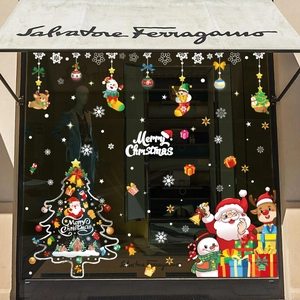 Christmas window stickers featuring Santa, snowman, and reindeer on glass display