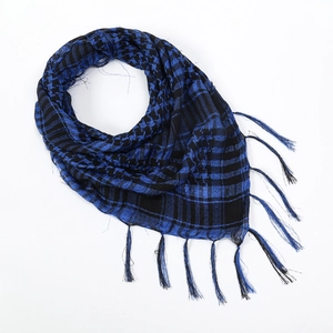 Detail of blue and black checkered shemagh scarf with woven fringe tassels and breathable texture