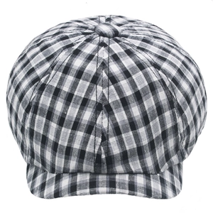 Detailed close-up of a black and white checkered newsboy cap with textured cotton fabric