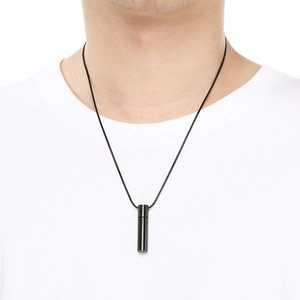 Minimalist black cylindrical pendant necklace on white shirt showing daily wear length
