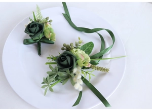 Detailed view of dark green PE rose boutonniere and wrist corsage for forest weddings