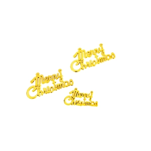 Three golden Merry Christmas cake toppers in varying sizes on a clean white background