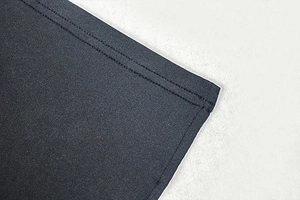 Macro shot of double-line stitching and premium knit fabric texture on dress hem
