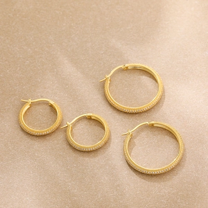 Detail of two pairs of 18K gold plated hoop earrings with micro-pave cubic zirconia