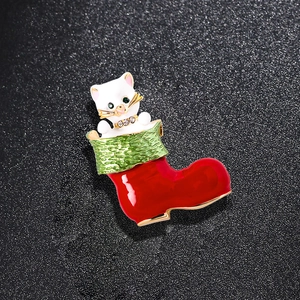 Christmas brooch featuring a white cat in a red and green stocking with rhinestones