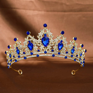 Detailed close-up of golden bridal crown featuring blue gemstones and sparkling rhinestones