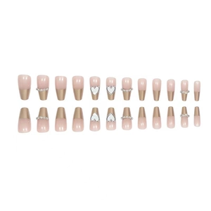 Long trapezoid press-on nails in warm nude and champagne gold with heart patterns