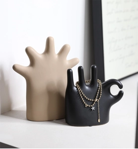 Detail of Nordic ceramic hand sculpture used as a ring and jewelry display stand