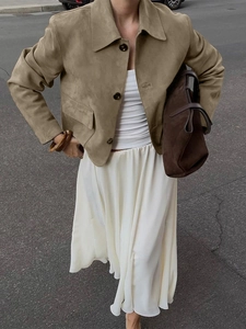 Women's khaki suede button jacket outfit with white maxi skirt and brown handbag