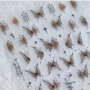 Close-up of matte semi-transparent nail stickers featuring ink butterfly and bamboo designs