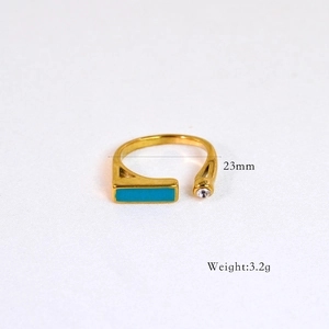 Macro detail of gold 14k ring with rectangular turquoise and clear crystal stones
